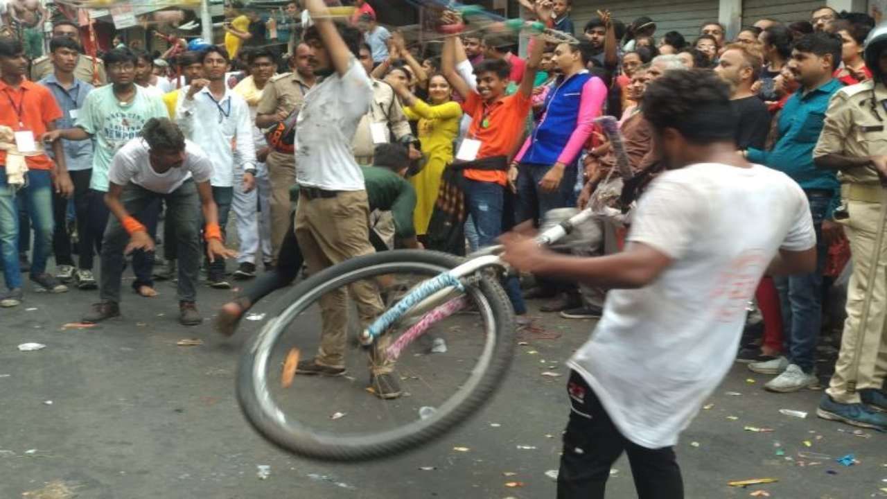 The performer grabbed the tooth and turned the bicycle